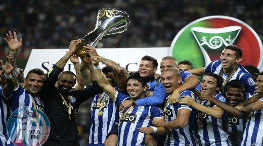 Porto's players celebrate with the trophy after winning the Supercup football match FC Porto vs VSC Guimaraes at Aveiro City Stadium in Aveiro on August 10, 2013. Porto defeated Guimaraes 3-0. AFP PHOTO/ FRANCISCO LEONG