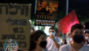 Israeli anti-government protesters carry placards during a demonstration against Prime Minister Benjamin Netanyahu, amidst the coronavirus lockdown, in the coastal city of Tel Aviv, on October 6, 2020. (Photo by JACK GUEZ / AFP) (Photo by JACK GUEZ/AFP via Getty Images)
