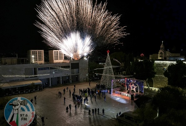 This picture taken on December 5, 2020 shows a fireworks display during the lighting of the Christmas tree in the biblical city of Bethlehem in the occupied West Bank, closed to the public due to the COVID-19 coronavirus pandemic. - Bethlehem lit up its Christmas tree evening on December 5 but without the usual crowds, as novel coronavirus restrictions put a damper on the start of Christmas festivities in the holy city. Palestinian authorities had the prior week announced measures, including a night-time curfew, across the Israeli-occupied West Bank for 14 days to fight a "worrying spread" of the virus. (Photo by EMMANUEL DUNAND / AFP) (Photo by EMMANUEL DUNAND/AFP via Getty Images)