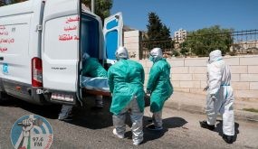 Staff of the Palestinian Ministry of Health in full hazmat suits transport the body of 47-year-old Palestinian COVID-19 victim Nassra Abu Hussein for burial in the West Bank city of Hebron, on June 29, 2020. (Photo by HAZEM BADER / AFP) (Photo by HAZEM BADER/AFP via Getty Images)