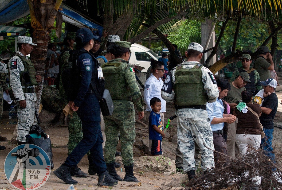 National guard members stand guard along the banks of the Suchiate river in Ciudad Hidalgo, Chiapas State, Mexico, to prevent illegal crossings across the border river to and from Tecun Uman in Guatemala, on July 3, 2019. (Photo by STR / AFP)