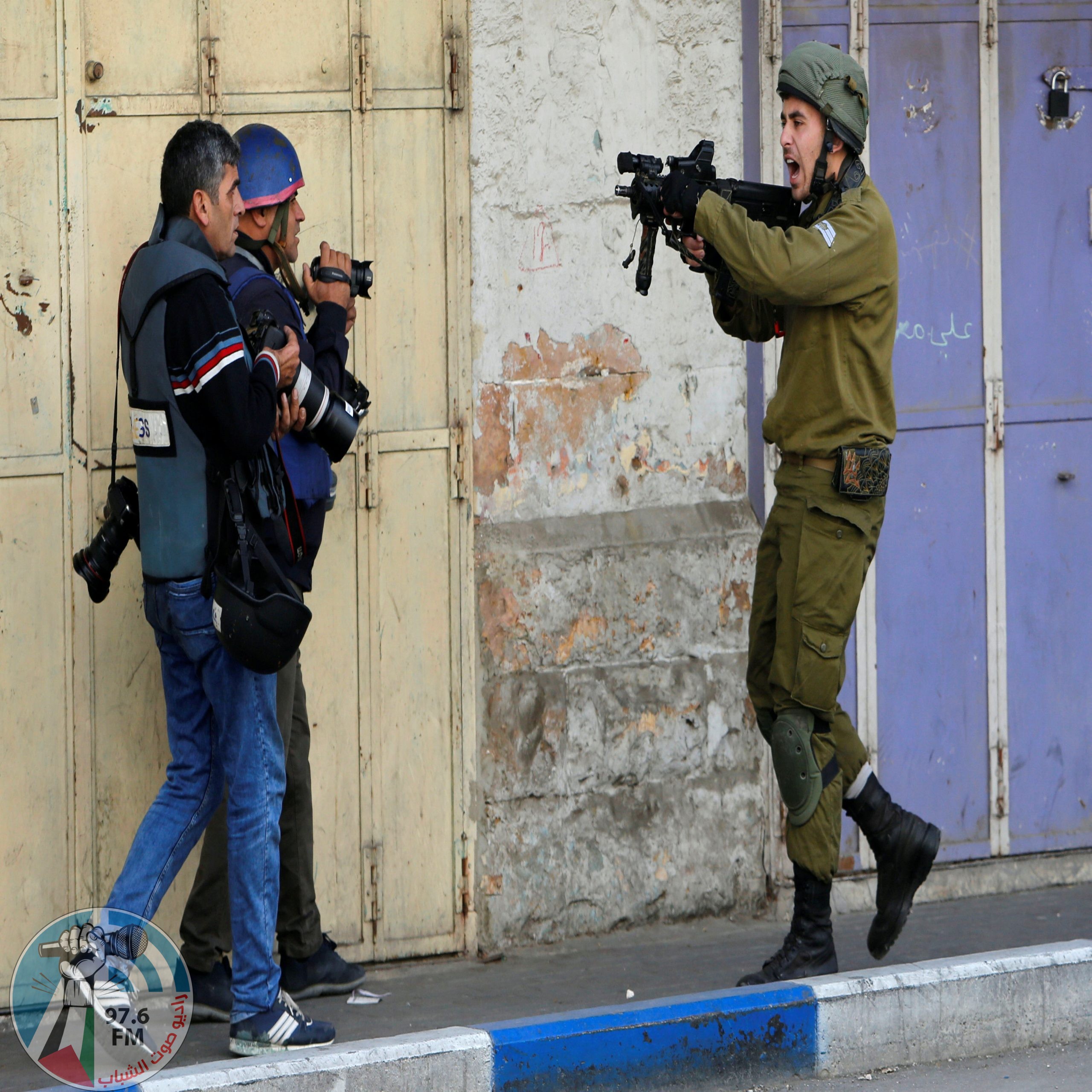An Israeli soldier shouts as he aims his weapon during clashes with Palestinian demonstrators at a protest against U.S. President Donald Trump's decision to recognise Jerusalem as the capital of Israel, in the West Bank city of Hebron December 15, 2017. REUTERS/Mussa Qawasma