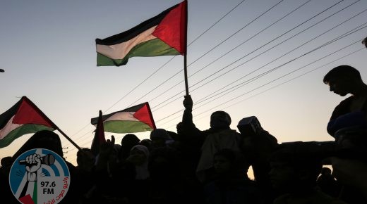TOPSHOT - Palestinian protesters wave their national flags at sunset during a demonstration near the Erez crossing with Israel on September 4, 2018, in the northern Gaza Strip protesting against the United States decision to stop funding and backing the United Nations agency for Palestinian refugees(UNRWA). (Photo by MAHMUD HAMS / AFP)