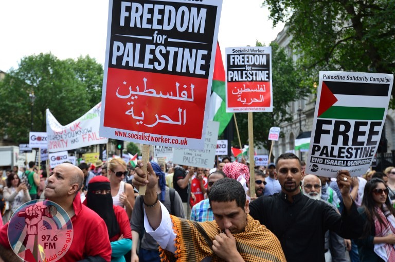 Protesters display placards and banners as they take part in demonstration against Israeli airstrikes in Gaza in central London on July 19, 2014 against Gaza strikes. Thousands of protesters gathered in London to participate in a march from Downing Street to the Israeli embassy, calling for an end to Israeli military action in Gaza. AFP PHOTO / CARL COURT