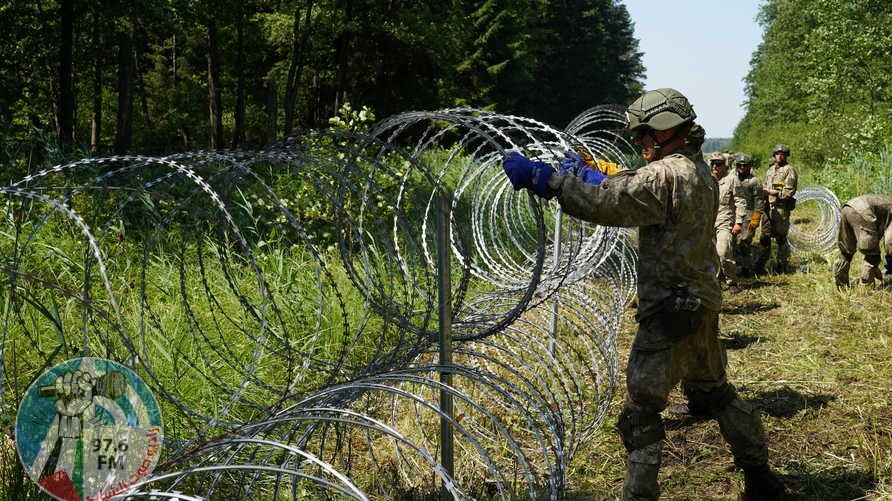 Lithuanian army soldiers install razor wire on border with Belarus in Druskininkai, Lithuania July 9, 2021. REUTERS/Janis Laizans