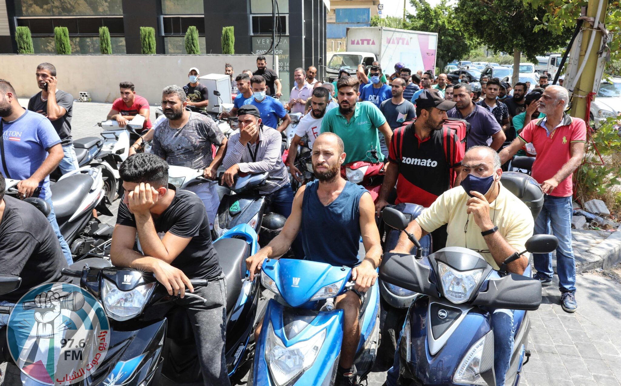 Scooter drivers queue in front of a petrol station in the Lebanese capital Beirut on August 13, 2021, amidst a wave of shortages of basic items due to a severe economic crisis. (Photo by ANWAR AMRO / AFP)