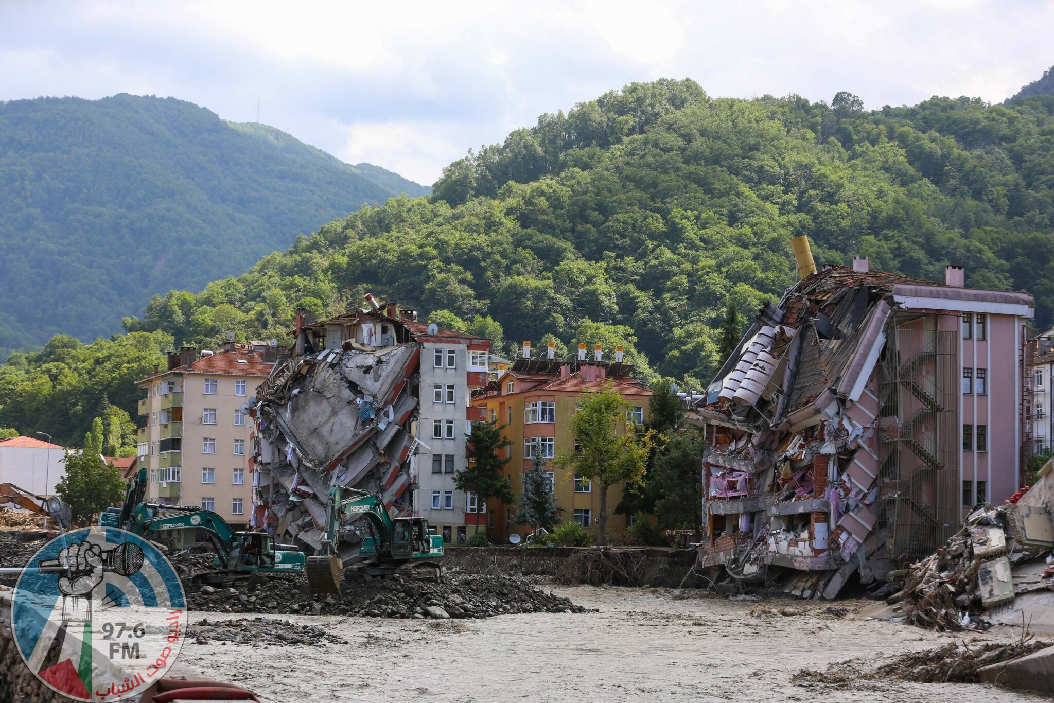 The front of two buildings are collapsed after the Ezine river broke it's banks during flash floods in Bozkurt in the district of Kastamonu, in the Black Sea region of Turkey on August 14, 2021. Turkey battled disaster on two fronts on August 14, 2021, with eight people dying when a fire-fighting aircraft crashed and rescuers racing to find survivors of flash floods in the north that have killed at least 55. (Photo by AFP)