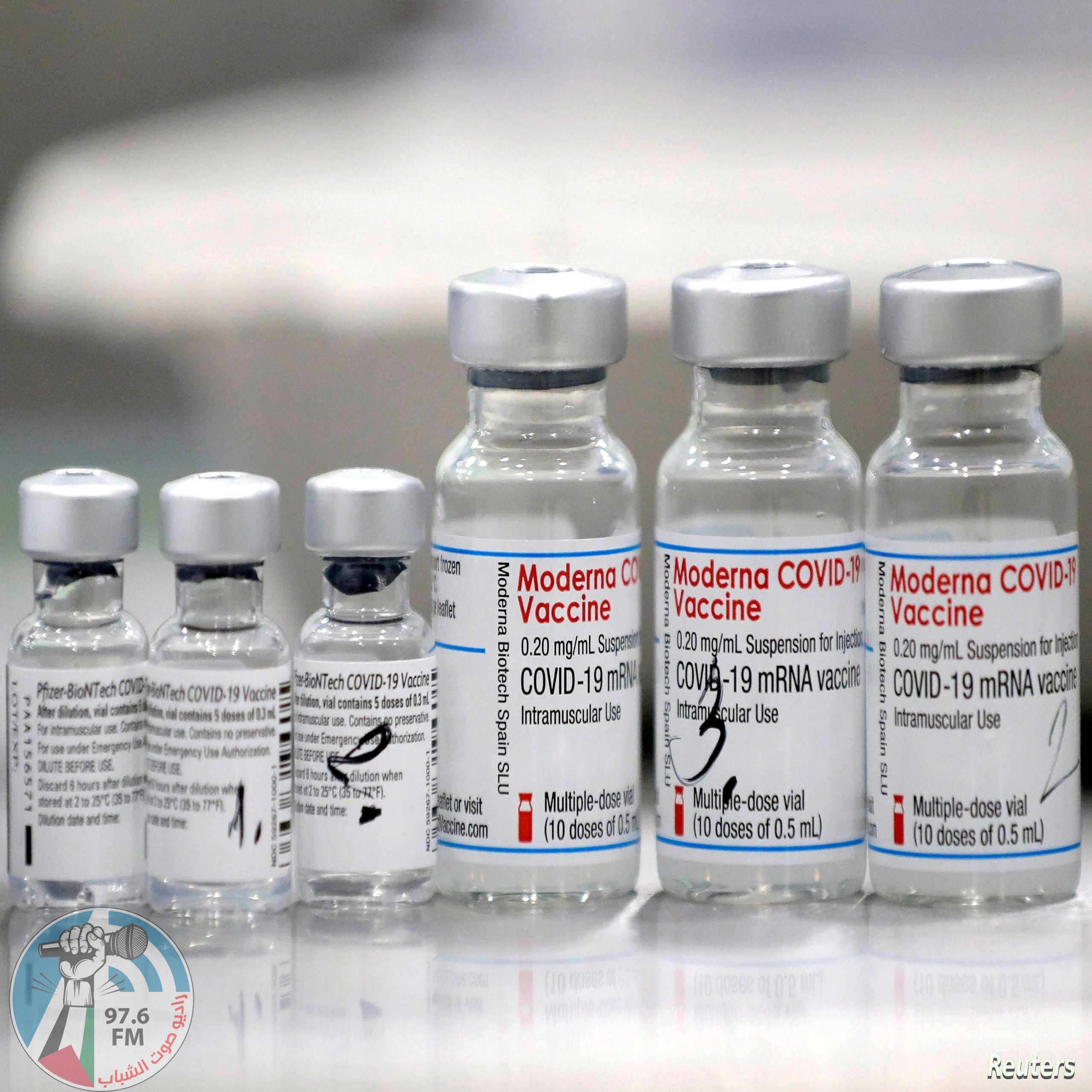 FILE PHOTO: Vials of coronavirus disease (COVID-19) vaccines of Pfizer-BioNTech and Moderna are seen in the town of Ricany near Prague, Czech Republic, February 25, 2021. REUTERS/David W Cerny/File Photo