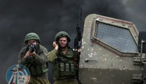 TOPSHOT - An Israeli soldier aims his weapon during clashes with Palestinian protesters following a demonstration against the expropriation of Palestinian land by Israel in the village of Kfar Qaddum, near Nablus in the occupied West Bank, on September 15, 2017. / AFP PHOTO / JAAFAR ASHTIYEH (Photo credit should read JAAFAR ASHTIYEH/AFP/Getty Images)