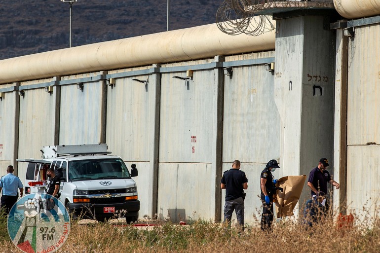Israeli security personnel stand together outside the walls of Gilboa prison after six Palestinian militants broke out of it in north Israel September 6, 2021. REUTERS/ Gil Eliyahu