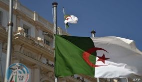 The Algerian national flag flies at half mast in the capital Algiers on September 18, 2021, following the death of former president Abdelaziz Bouteflika. - Bouteflika, who ruled Algeria for two decades before resigning in 2019 as huge protests engulfed the country, has died aged 84, public television announced. The former strongman had left office in April 2019 under pressure from the military, following weeks of demonstrations over his bid to run for a fifth term in office. (Photo by RYAD KRAMDI / AFP)