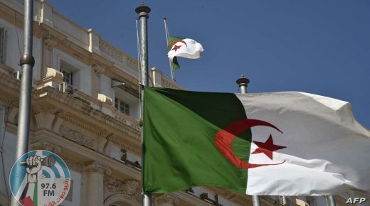 The Algerian national flag flies at half mast in the capital Algiers on September 18, 2021, following the death of former president Abdelaziz Bouteflika. - Bouteflika, who ruled Algeria for two decades before resigning in 2019 as huge protests engulfed the country, has died aged 84, public television announced. The former strongman had left office in April 2019 under pressure from the military, following weeks of demonstrations over his bid to run for a fifth term in office. (Photo by RYAD KRAMDI / AFP)