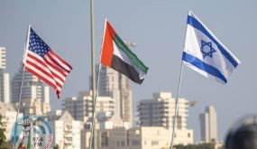 A woman wearing a face mask against the coronavirus pandemic walks past American, United Arab Emirates, Israel and Bahraini flags at the Peace Bridge in Netanya, Israel, Monday, Sept. 14, 2020. For the first time in more than a quarter-century, a U.S. president will host a signing ceremony between Israelis and Arabs at the White House, billing it as an "historic breakthrough" in a region long known for its stubborn conflicts. (AP Photo/Ariel Schalit);أعلام الأمارات وأمريكا واسرائيل والبحرين ترفرف في بلدة ناتانيا الاسرائيلية