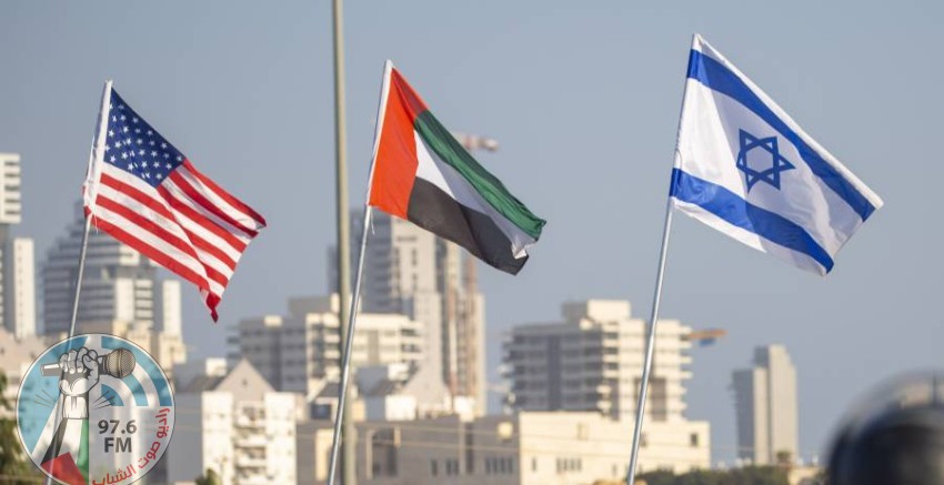 A woman wearing a face mask against the coronavirus pandemic walks past American, United Arab Emirates, Israel and Bahraini flags at the Peace Bridge in Netanya, Israel, Monday, Sept. 14, 2020. For the first time in more than a quarter-century, a U.S. president will host a signing ceremony between Israelis and Arabs at the White House, billing it as an "historic breakthrough" in a region long known for its stubborn conflicts. (AP Photo/Ariel Schalit);أعلام الأمارات وأمريكا واسرائيل والبحرين ترفرف في بلدة ناتانيا الاسرائيلية