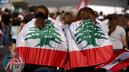 (FILES) In this file photo taken on October 27, 2019, Lebanese protesters wrapped in their national flag take part in a human chain along the coast from north to south as a symbol of unity during ongoing anti-government demonstrations in the area of Jal al-Dib in the northern outskirts of the Lebanese capital Beirut. Two years after a now-defunct protest movement shook Lebanon, opposition activists are hoping parliamentary polls will challenge the ruling elite's stranglehold on the country. (Photo by Patrick BAZ / AFP)