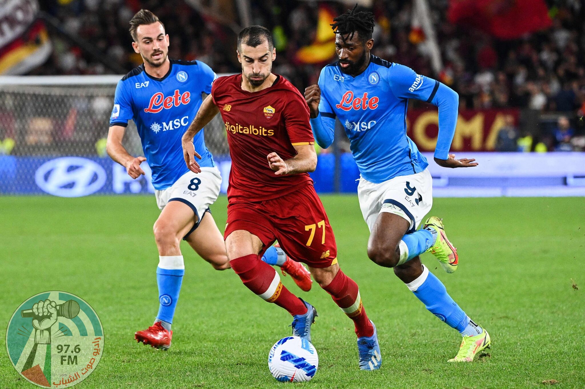 Roma's Armenian midfielder Henrikh Mkhitaryan (C) fights for the ball with Napoli's Spanish midfielder Fabian Ruiz (L) and Napoli's Cameroonian midfielder Andre Zambo Anguissa during the Italian Serie A football match between AS Roma and Napoli at the Olympic stadium in Rome, on October 24, 2021. (Photo by Vincenzo PINTO / AFP)