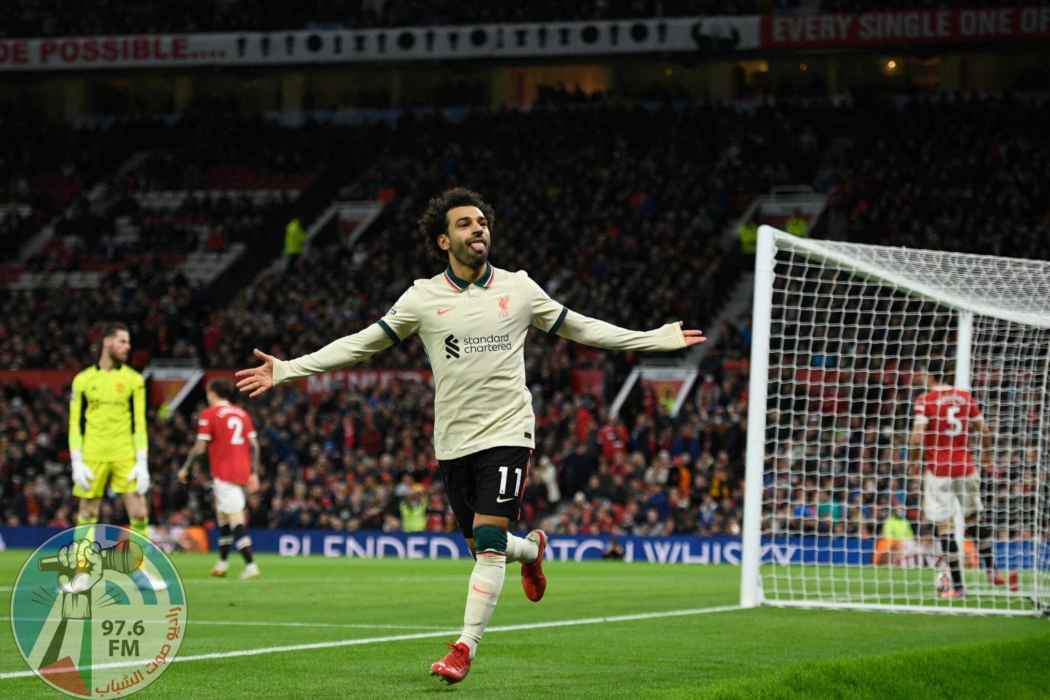 TOPSHOT - Liverpool's Egyptian midfielder Mohamed Salah celebrates after scoring their fifth goal, his third during the English Premier League football match between Manchester United and Liverpool at Old Trafford in Manchester, north west England, on October 24, 2021. RESTRICTED TO EDITORIAL USE. No use with unauthorized audio, video, data, fixture lists, club/league logos or 'live' services. Online in-match use limited to 120 images. An additional 40 images may be used in extra time. No video emulation. Social media in-match use limited to 120 images. An additional 40 images may be used in extra time. No use in betting publications, games or single club/league/player publications. (Photo by Oli SCARFF / AFP) / RESTRICTED TO EDITORIAL USE. No use with unauthorized audio, video, data, fixture lists, club/league logos or 'live' services. Online in-match use limited to 120 images. An additional 40 images may be used in extra time. No video emulation. Social media in-match use limited to 120 images. An additional 40 images may be used in extra time. No use in betting publications, games or single club/league/player publications.