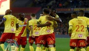 Len's French defender Jonathan Clauss (C) celebrates with teammates after scoring during the French Ligue 1 football match between RC Lens and ES Troyes AC at the Bollaert Stadium in Lens, on november 5, 2021. (Photo by FRANCOIS LO PRESTI / AFP)