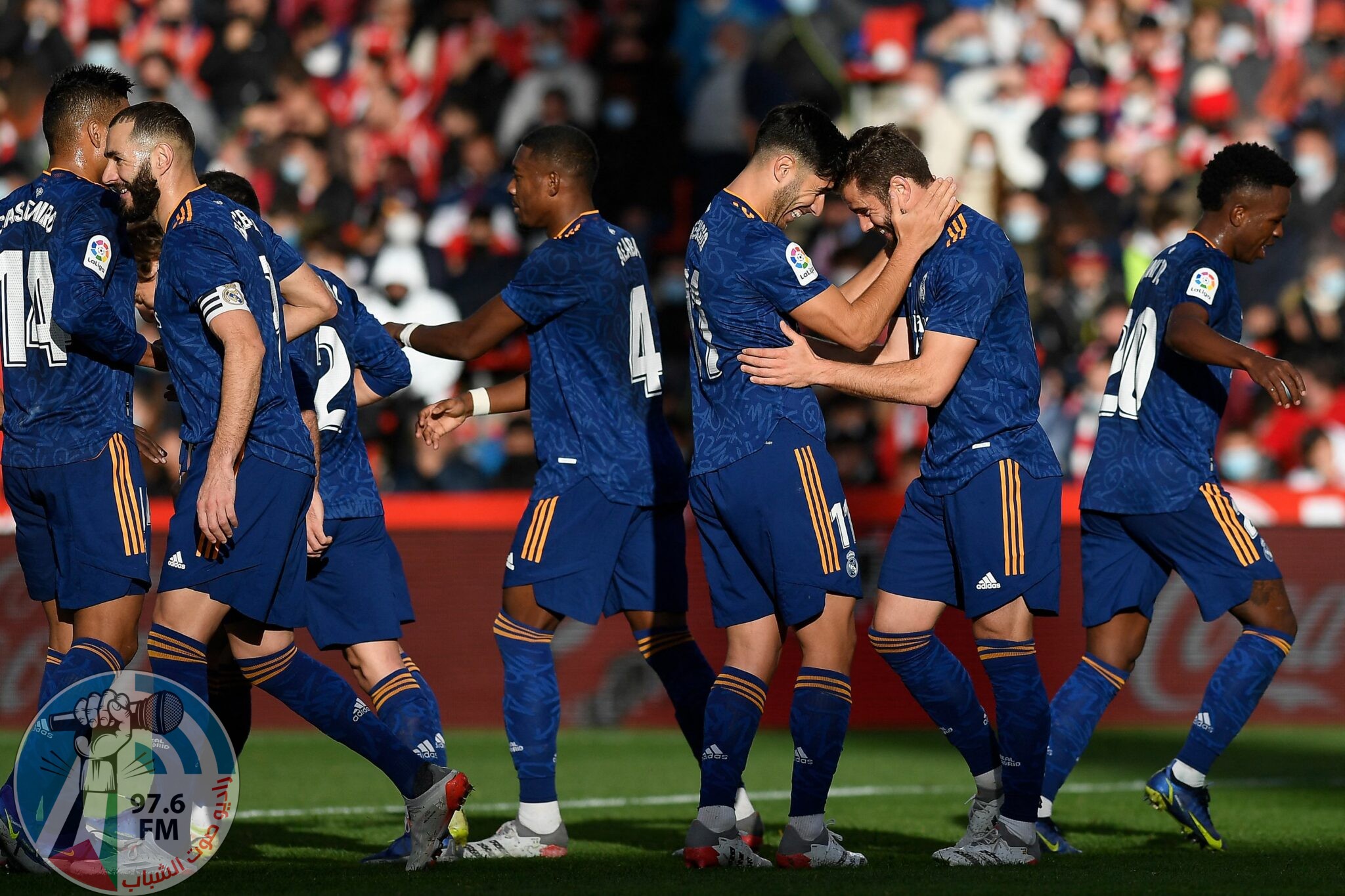 Real Madrid's Spanish defender Nacho Fernandez (2nd-R) celebrates with teammates after scoring his team's second goal during the Spanish League football match between Granada FC and Real Madrid CF at Nuevo Los Carmenes stadium in Granada on November 21, 2021. (Photo by JORGE GUERRERO / AFP)