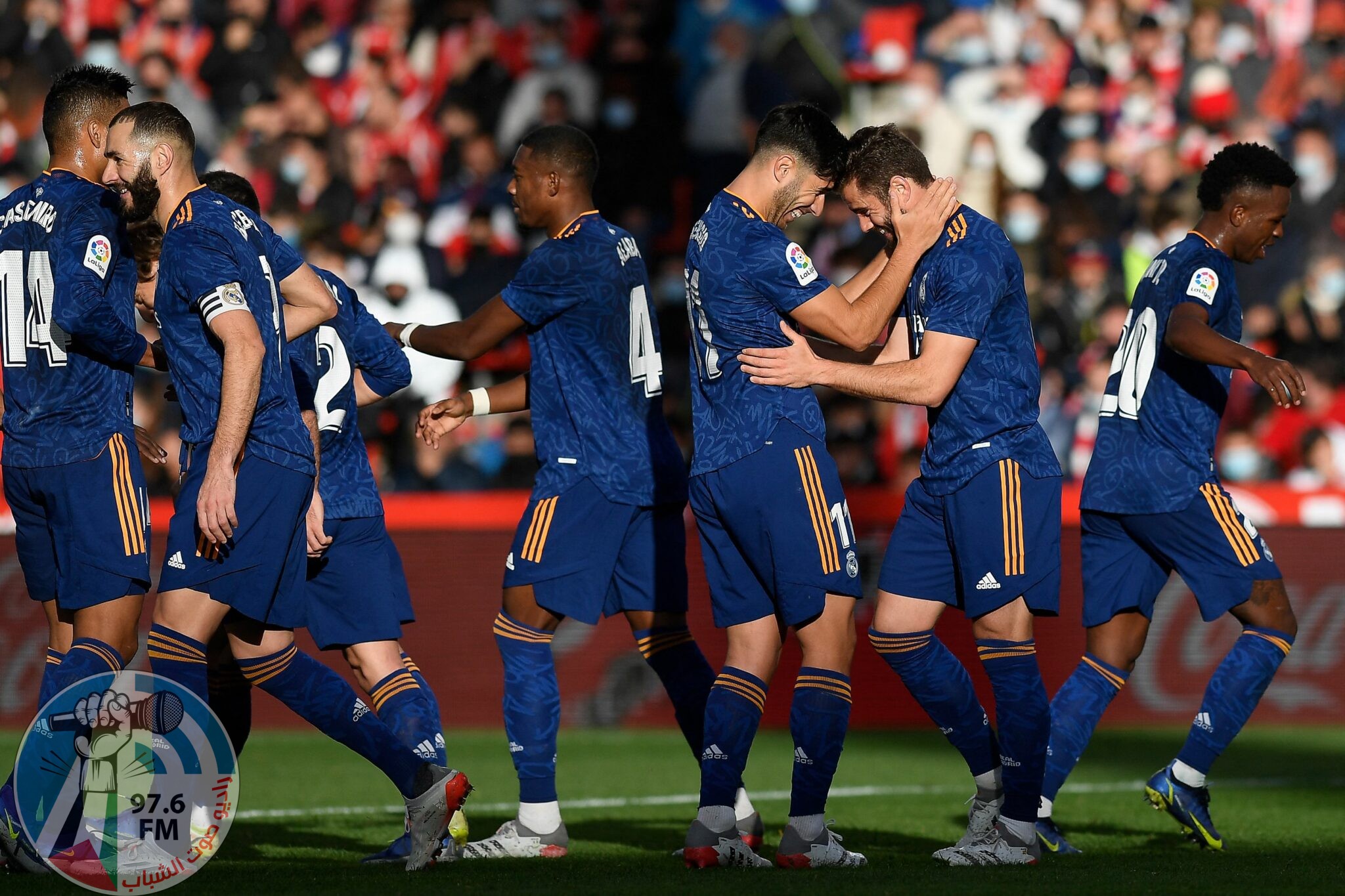 Real Madrid's Spanish defender Nacho Fernandez (2nd-R) celebrates with teammates after scoring his team's second goal during the Spanish League football match between Granada FC and Real Madrid CF at Nuevo Los Carmenes stadium in Granada on November 21, 2021. (Photo by JORGE GUERRERO / AFP)