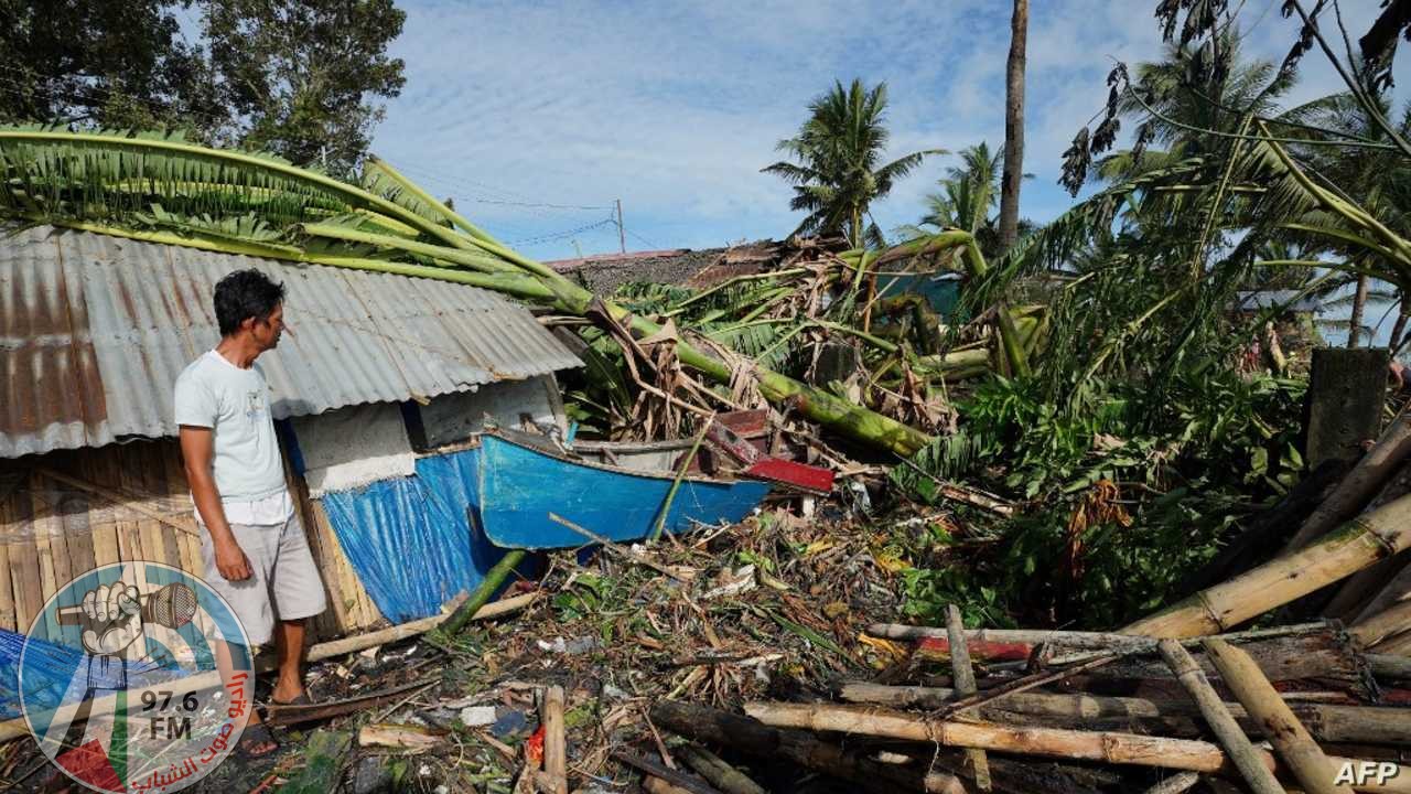 A resident looks at his damaged home in the coastal town of Dulag in Leyte province on December 17, 2021, a day after Super Typhoon Rai hit. (Photo by Bobbie ALOTA / AFP)