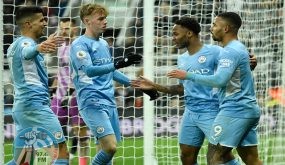 Manchester City's English midfielder Raheem Sterling (2nd R) celebrates with teammates after scoring their fourth goal during the English Premier League football match between Newcastle United and Manchester City at St James' Park in Newcastle-upon-Tyne, north east England on December 19, 2021. RESTRICTED TO EDITORIAL USE. No use with unauthorized audio, video, data, fixture lists, club/league logos or 'live' services. Online in-match use limited to 120 images. An additional 40 images may be used in extra time. No video emulation. Social media in-match use limited to 120 images. An additional 40 images may be used in extra time. No use in betting publications, games or single club/league/player publications. (Photo by Oli SCARFF / AFP) / RESTRICTED TO EDITORIAL USE. No use with unauthorized audio, video, data, fixture lists, club/league logos or 'live' services. Online in-match use limited to 120 images. An additional 40 images may be used in extra time. No video emulation. Social media in-match use limited to 120 images. An additional 40 images may be used in extra time. No use in betting publications, games or single club/league/player publications.