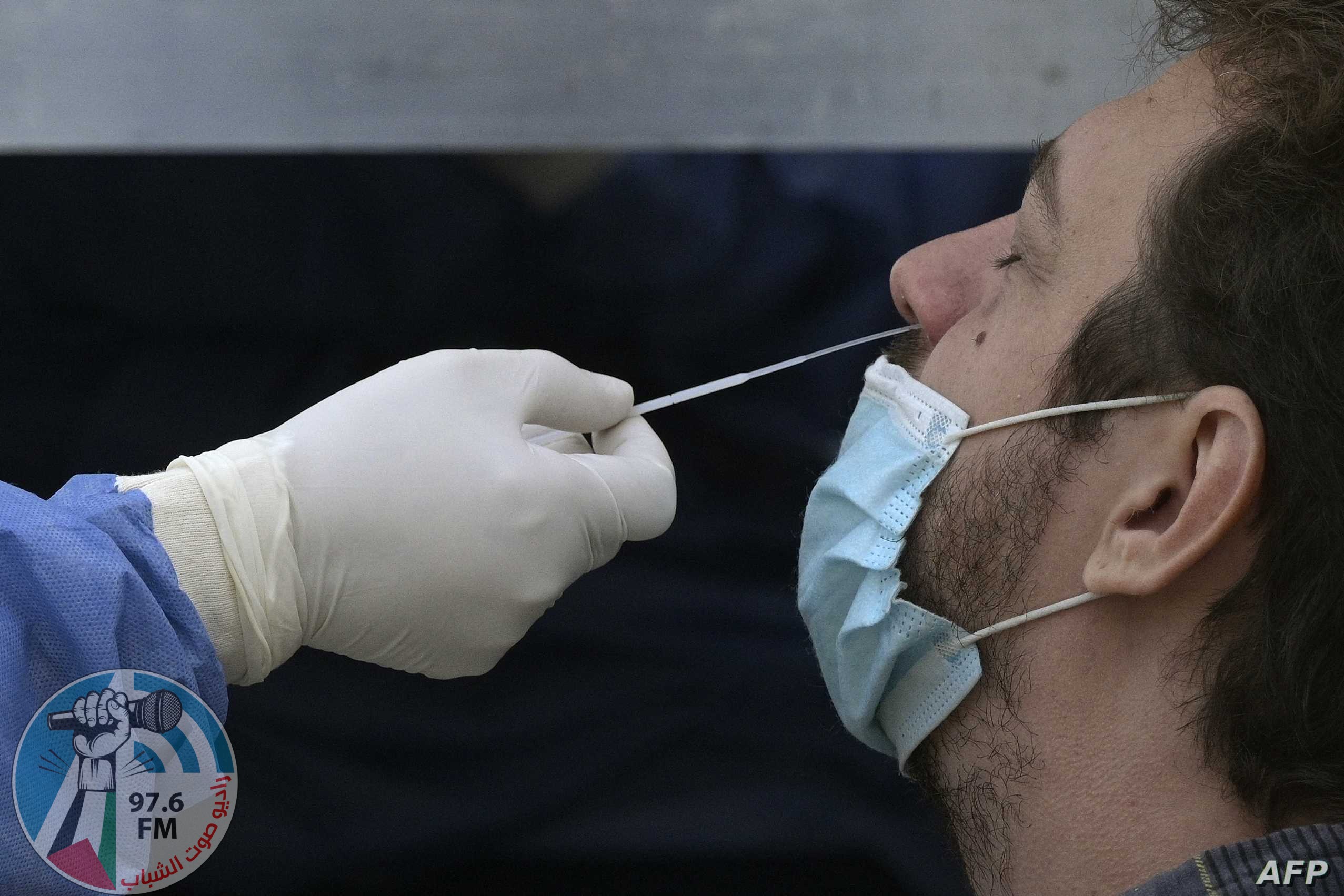 A health worker wearing protective gear collects a nasal swab for a Covid-19 PCR test at Plaza de Mayo square in Buenos Aires, on May 28, 2021. (Photo by JUAN MABROMATA / AFP)