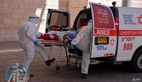 Medics with the Magen David Adom transfer a Coronavirus patient to the Hadassah Ein Kerem Hospital in Jerusalem due to full capacity in other hospitals, following a sharp increase in the number of coronavirus infections in Israel, on August 15, 2021. (Photo by Menahem KAHANA / AFP)