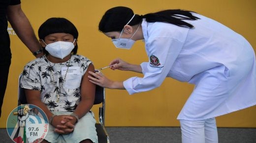 Brazilian indigenous boy Davi Xavante -the first child in Brazil to get vaccinated against COVID-19- receives the first dose of the Pfizer-BioNTech vaccine at the Clinicas hospital in Sao Paulo, Brazil, on January 14, 2022. (Photo by NELSON ALMEIDA / AFP)
