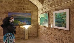 Visitors look at a paintings by Lebanese artists Shawki Chamoun (C) and Jamil Molaeb (R) during an exhibit showcasing art installations that were restored as part of a UNESCO initiative, after being damaged during the August 4 2020 port blast, at the Beirut Museum of Art in the Lebanese capital on January 20, 2022. - RESTRICTED TO EDITORIAL USE - MANDATORY MENTION OF THE ARTIST UPON PUBLICATION - TO ILLUSTRATE THE EVENT AS SPECIFIED IN THE CAPTION (Photo by ANWAR AMRO / AFP) / RESTRICTED TO EDITORIAL USE - MANDATORY MENTION OF THE ARTIST UPON PUBLICATION - TO ILLUSTRATE THE EVENT AS SPECIFIED IN THE CAPTION