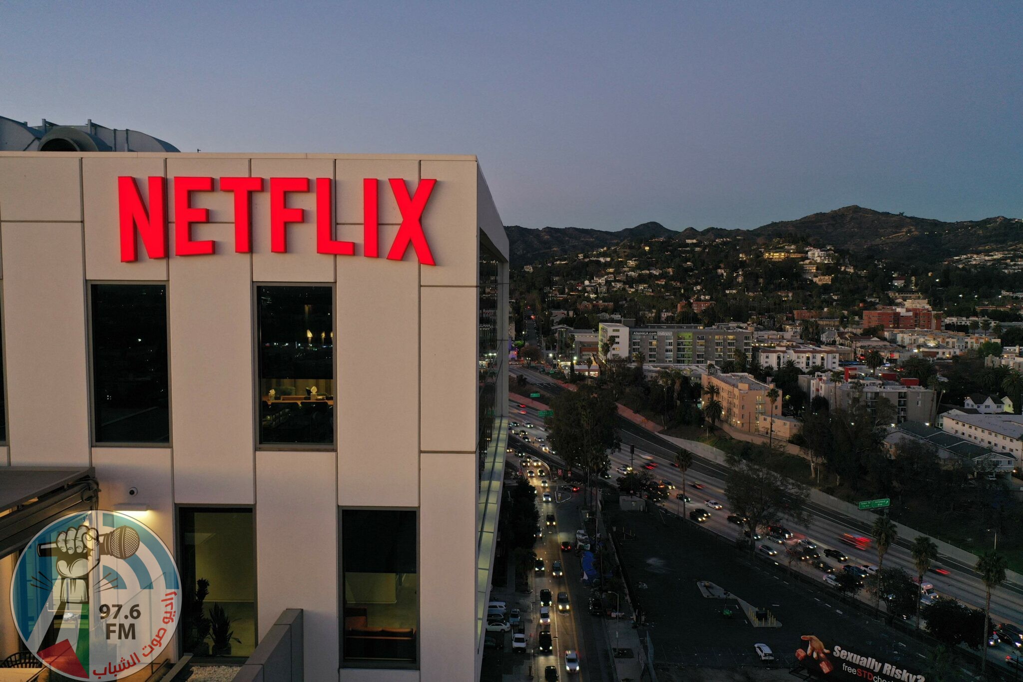 (FILES) In this file photo taken on January 20, 2022 the Netflix logo is seen on top of their office building in Hollywood, California. One day after shares of at-home fitness company Peloton tumbled, Netflix found itself in Wall Street's hot seat January 21, 2022 as markets reassess the diminishing growth prospects of so-called "pandemic stocks." (Photo by Robyn Beck / AFP)