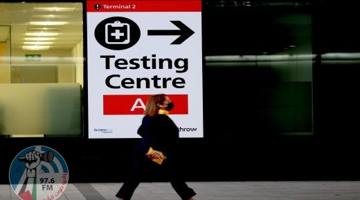 (211201) -- LONDON, Dec. 1, 2021 (Xinhua) -- A passenger walks past a placard indicating the testing center in Heathrow Airport in London, Britain, Nov. 30, 2021. British Prime Minister Boris Johnson said Saturday all travellers entering Britain must take a PCR test by the end of the second day after their arrival, and must self-isolate until they receive a negative test result. Passengers arriving in Britain from countries in Britain's travel "red list", including South Africa, from 0400 GMT on Nov. 28 will be required to book and pay for a government-approved hotel to quarantine for 10 days. Omicron, a new COVID-19 variant, has been detected in a growing number of countries and regions worldwide, prompting governments to tighten their restrictions and impose new travel bans. (Xinhua/Li Ying)