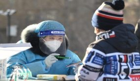 (220115) -- TIANJIN, Jan. 15, 2022 (Xinhua) -- A medical worker helps a kid register for nucleic acid test at a COVID-19 testing site in north China's Tianjin, Jan. 15, 2022. North China's Tianjin Municipality launched the third round of citywide nucleic acid testing at 7 a.m. Saturday. (Xinhua/Sun Fanyue)
