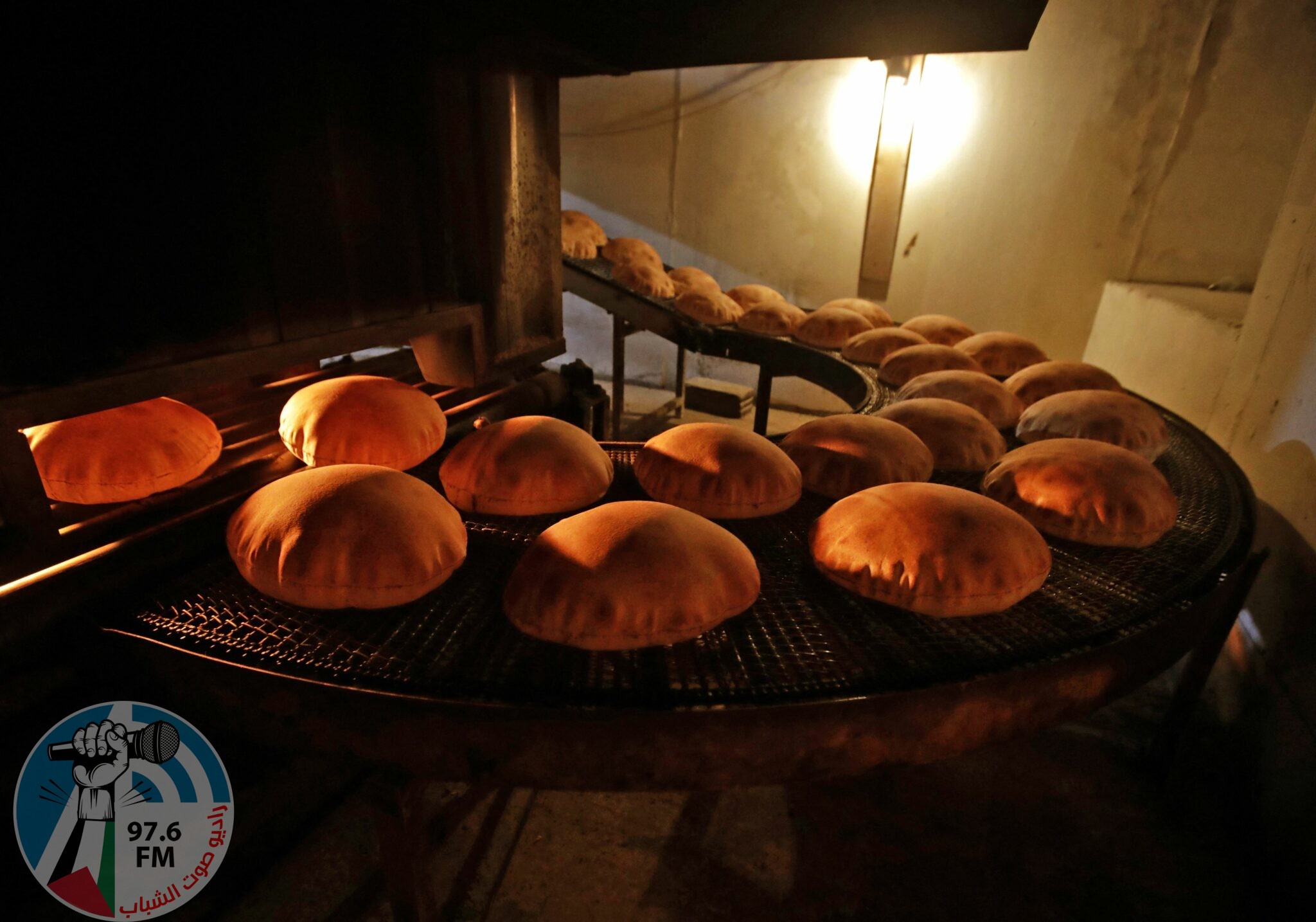 (FILES) In this file photo taken on July 1, 2020 freshly-baked bread moves along a production line out of an oven at an automated bakery in Lebanon's capital Beirut. Russia's invasion of Ukraine could mean less bread on the table in Egypt, Lebanon, Yemen and elsewhere in the Arab world where millions already struggle to survive. The region is heavily dependent on wheat supplies from the two countries which are now at war, and any shortages of the staple food have potential to bring unrest. (Photo by JOSEPH EID / AFP)