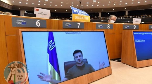 TOPSHOT - Ukrainian President Volodymyr Zelensky appears on a screen as he speaks in a video conference during a special plenary session of the European Parliament focused on the Russian invasion of Ukraine at the EU headquarters in Brussels, on March 01, 2022. The European Commission has opened the door for Ukraine to join the EU, but this is not for tomorrow, despite Kiev's request for a special procedure to integrate the country "without delay". (Photo by JOHN THYS / AFP)