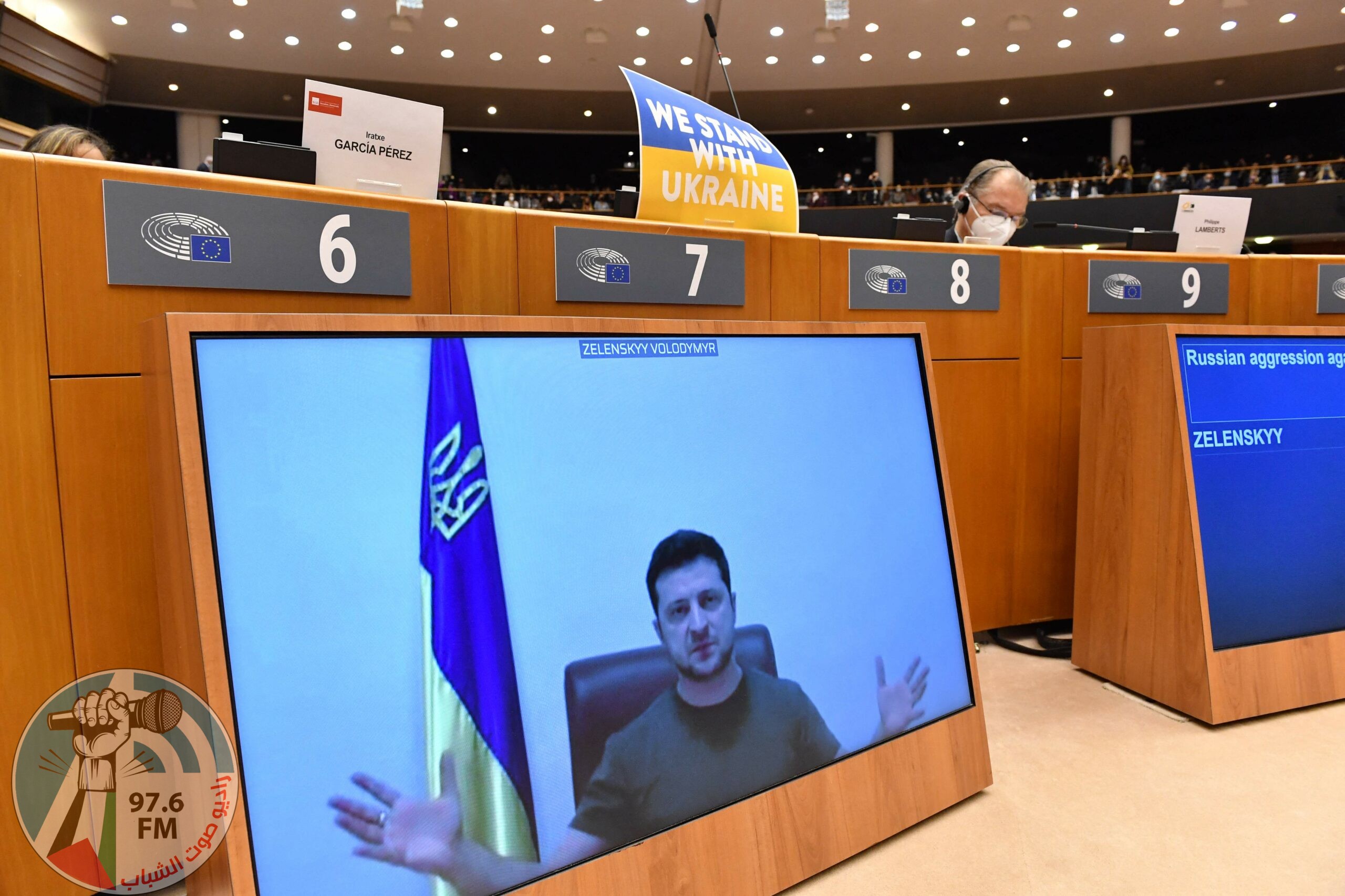 TOPSHOT - Ukrainian President Volodymyr Zelensky appears on a screen as he speaks in a video conference during a special plenary session of the European Parliament focused on the Russian invasion of Ukraine at the EU headquarters in Brussels, on March 01, 2022. The European Commission has opened the door for Ukraine to join the EU, but this is not for tomorrow, despite Kiev's request for a special procedure to integrate the country "without delay". (Photo by JOHN THYS / AFP)