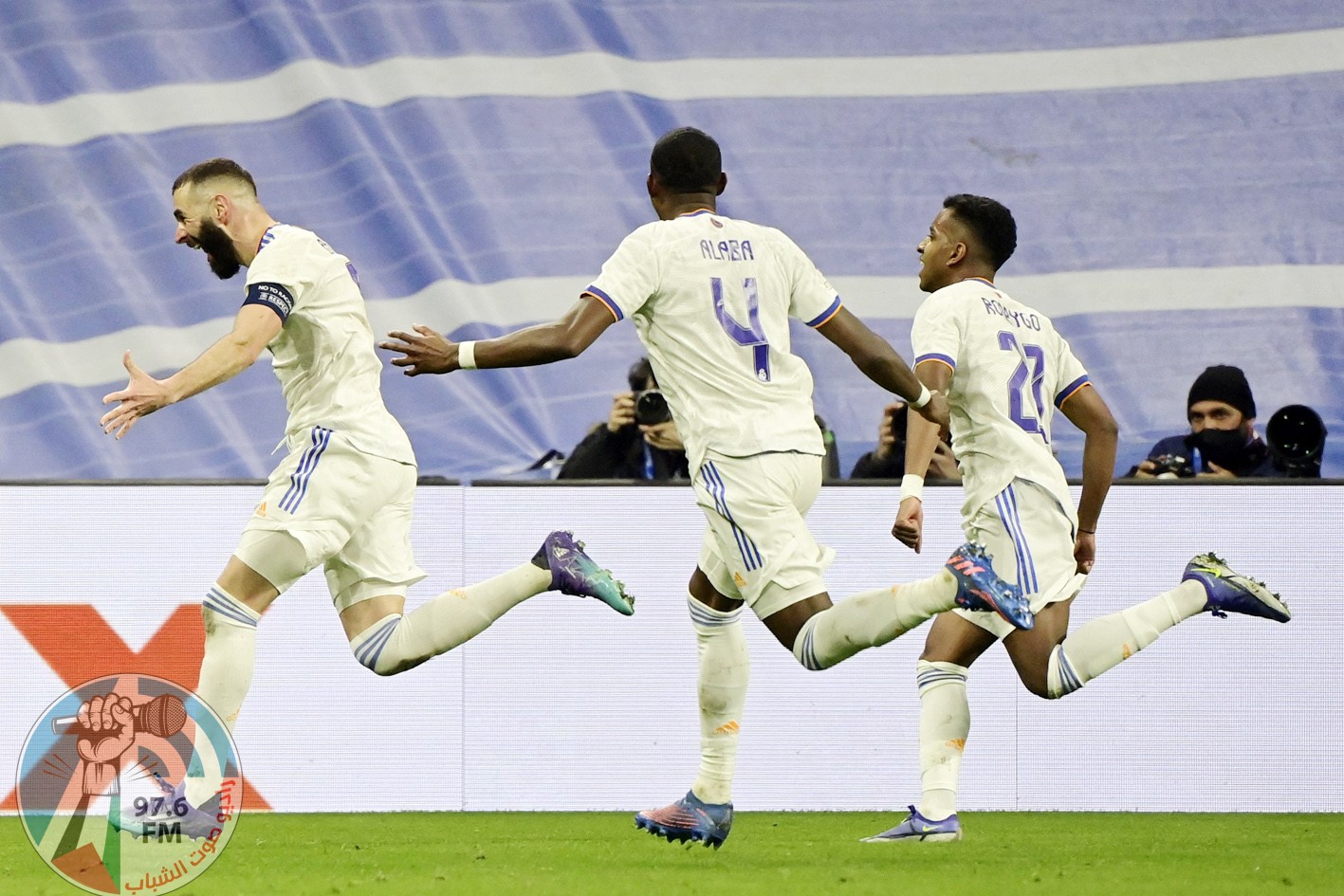 Real Madrid's French forward Karim Benzema (L) celebrates after scoring a goal during the UEFA Champions League round of 16 second league football match between Real Madrid CF and Paris Saint-Germain at the Santiago Bernabeu stadium in Madrid on March 9, 2022. (Photo by JAVIER SORIANO / AFP)